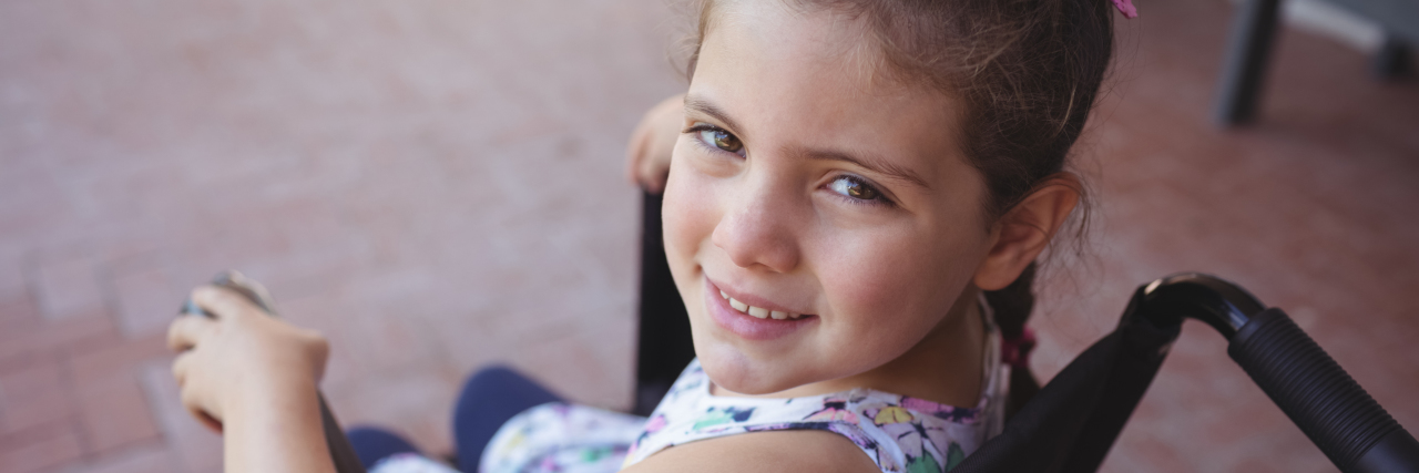 The Disability Lesson I Learned at Age 4 High angle portrait of schoolgirl sitting on wheelchair