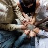 Group of diverse hands holding each other support together