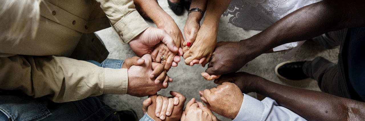 How I Dealt With Abuse and Insults Following My Traumatic Brain Injury Group of diverse hands holding each other support together