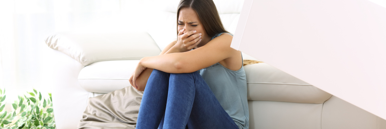 What Living With Depression Every Day Is Like woman on floor crying with mess all around her