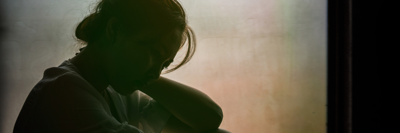 The Moment I Realized My Gastroparesis Is Lifelong silhouette of a woman sitting by a window