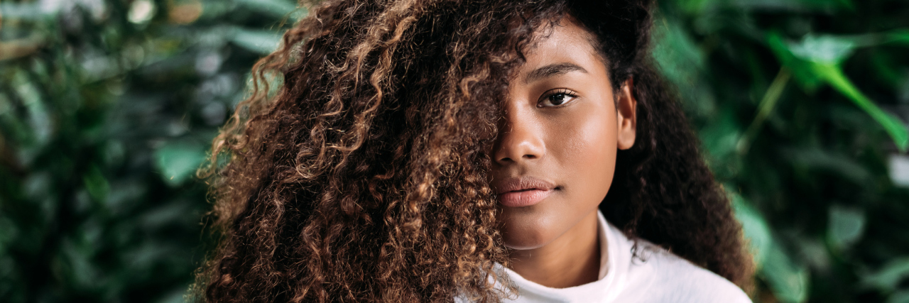 What Seeing the News Is Like as Someone Who is Both 'Woke' and Anxious girl with curly hair.