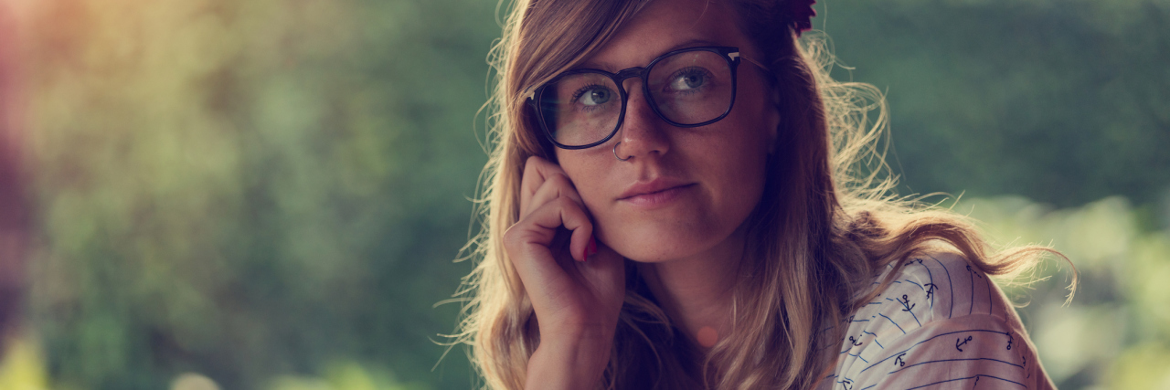 What My Existential Depression Has Taught Me About the Meaning of Life young woman in garden contemplative