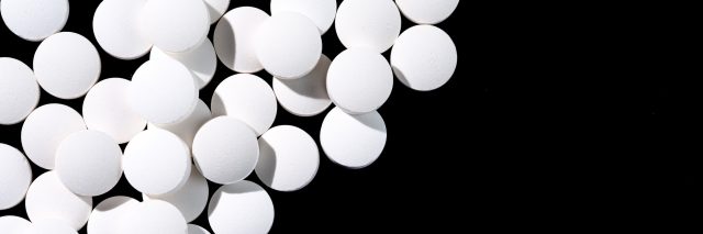 white pills on black countertop