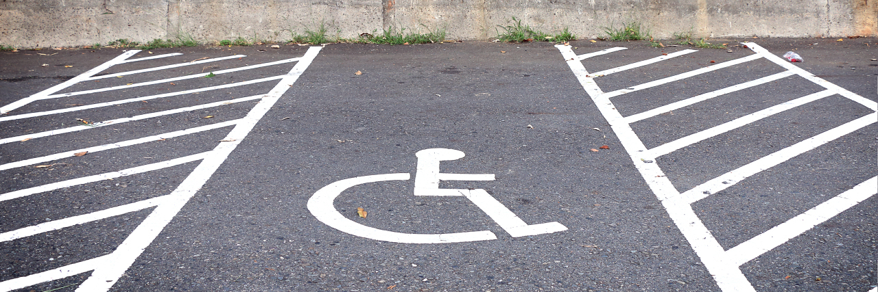 Disability Does Not Always Mean Wheelchair Parking lot with disabled parking.