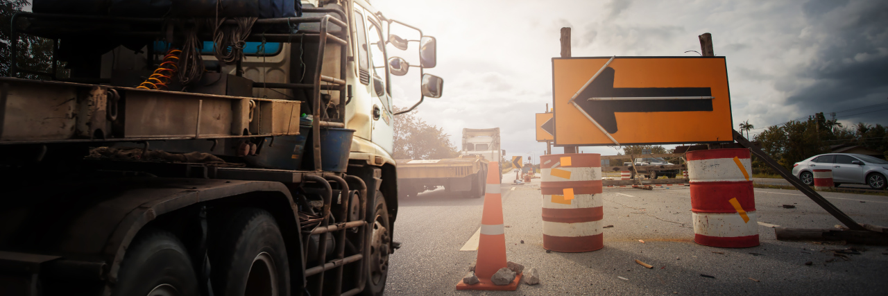 Truck with Traffic cones and " Diversion" sign outside a construction zone.