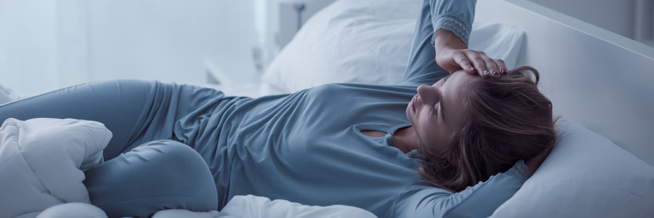 What It Means to Experience 'Payback' With Chronic Fatigue Syndrome A woman in bed looking tired.