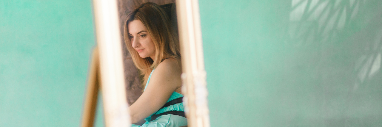 How Self-Awareness Can Help You in Mental Health Recovery selective focus of woman's reflection in mirror against green wall