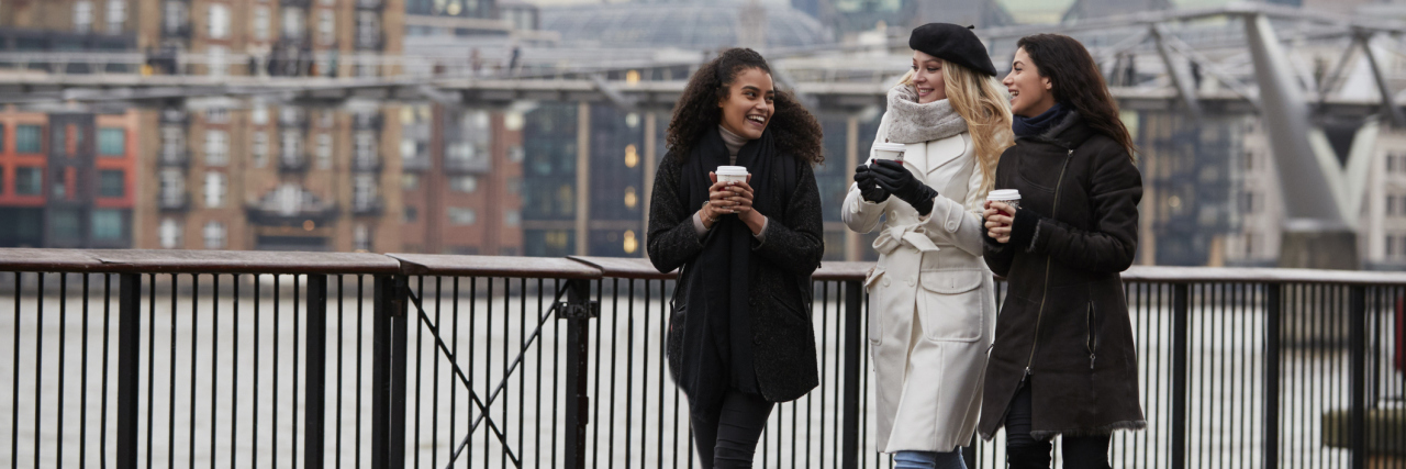 How You Can Help Your Chronically Ill Friends Feel Validated Three friends walking on a sidewalk in a city.