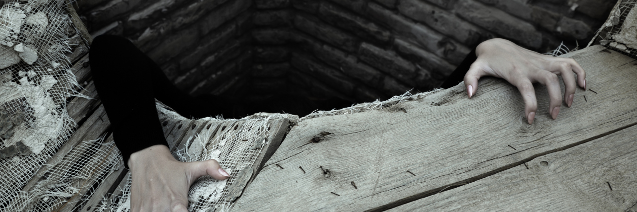 What It Feels Like When I Experience a Chronic Fatigue Syndrome Crash A person climbing out of a wooden well.