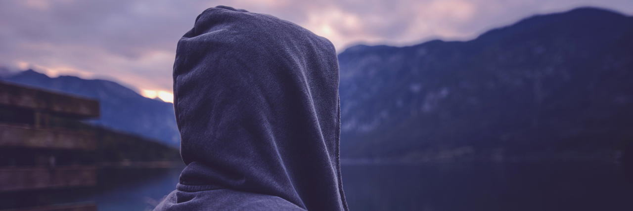 ‘Overthinking’ as a Person With Anxiety and Chronic Illness lonely woman standing by lake thinking