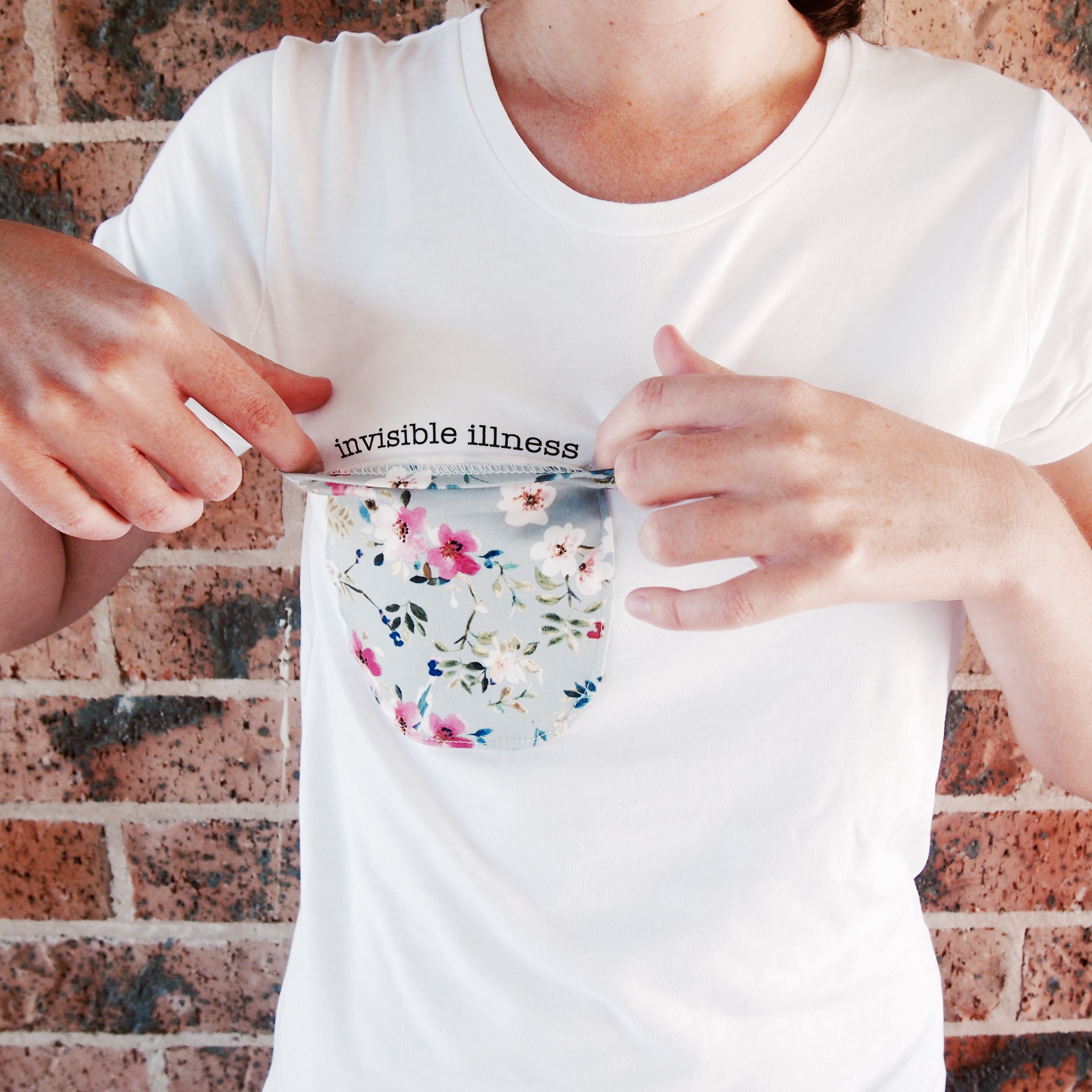 "invisible" tee with message under floral breast pocket