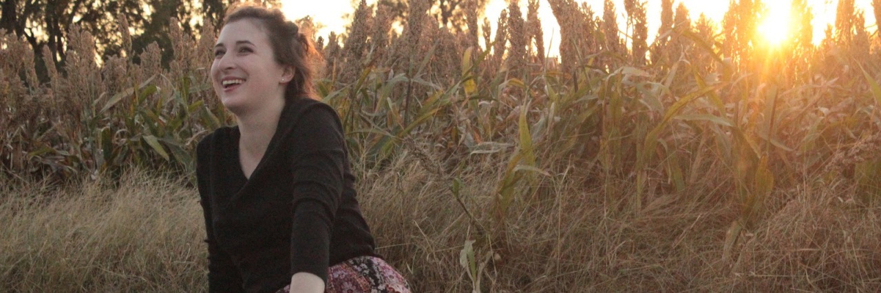 What Autism Looks Like for Me Tristan Barnes sitting on a blanket in the grass.
