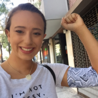 woman flexing her arm and wearing a PICC line cover