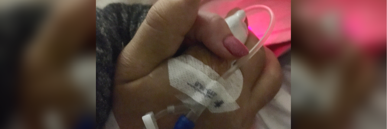 My Husband Passed Away From Cancer, but His Love Will Live On husband and wife holding hands while the husband lies in a hospital bed