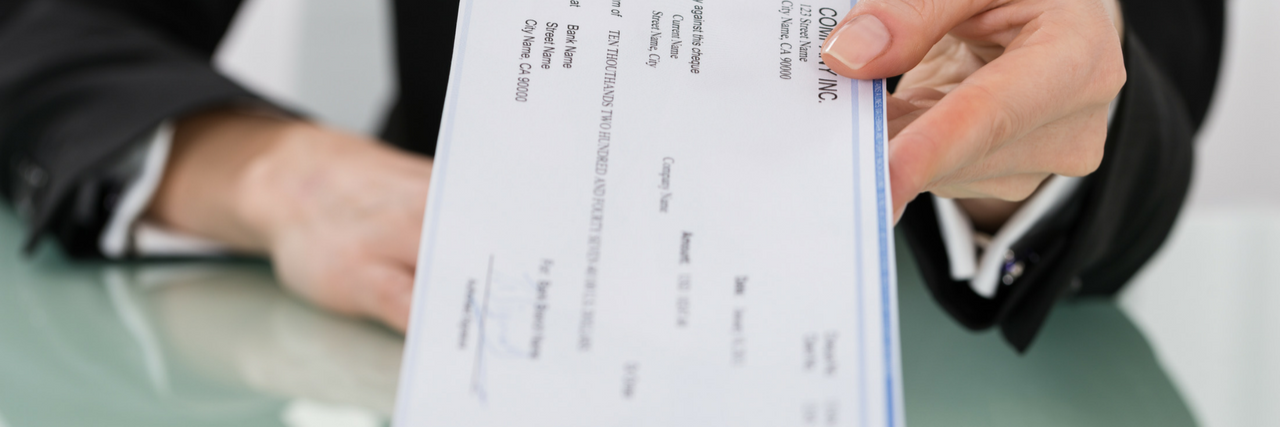 Alaska Ends Sub-Minimum Wages for Employees with Disabilities Someone handing out a paycheck