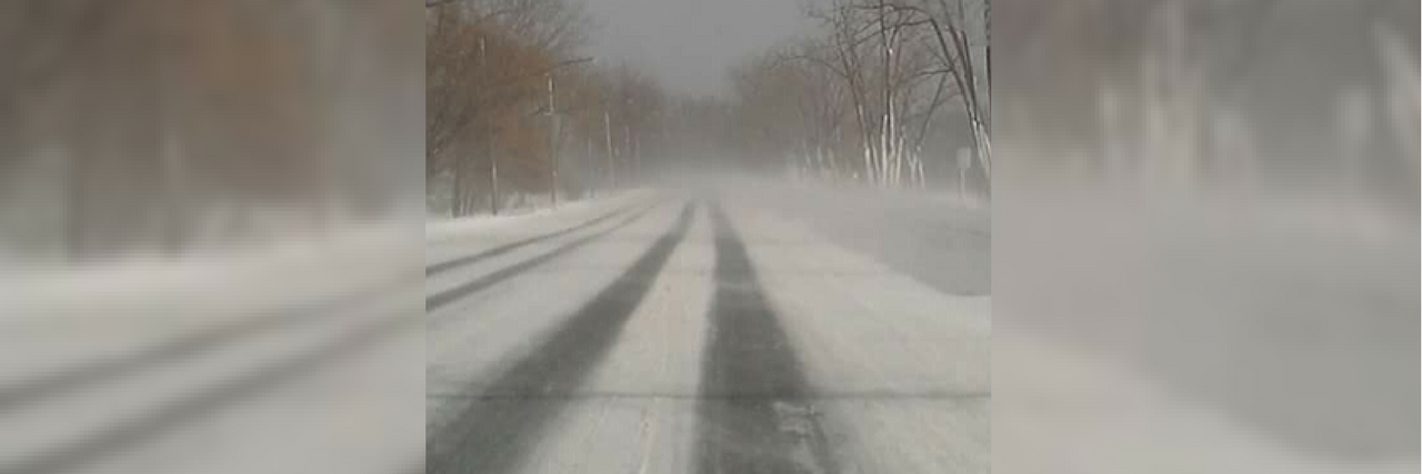 Coping With Disease Progression snowy road with tire tracks leading into a forest