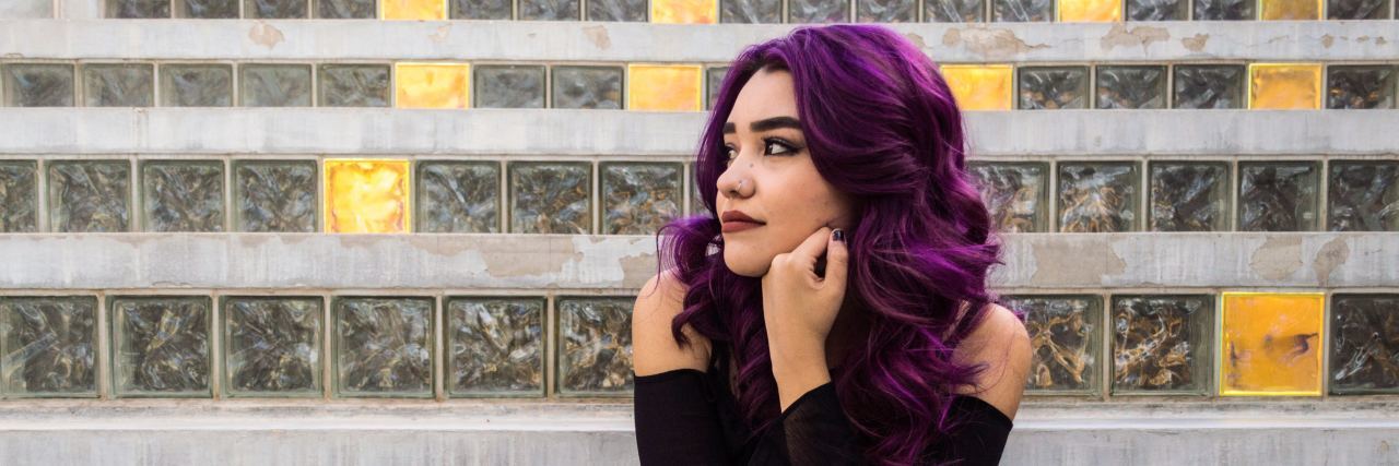What I Discovered After Trying 4 Different Types of Therapy woman with purple hair sitting on steps