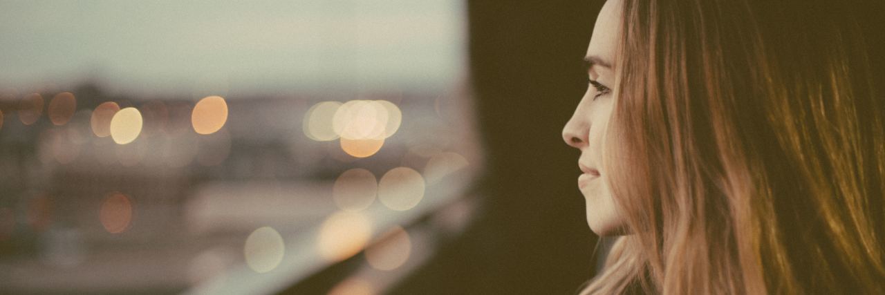 Why I Try to Stay Positive Through My Multiple Myeloma Cancer woman smiling looking outside