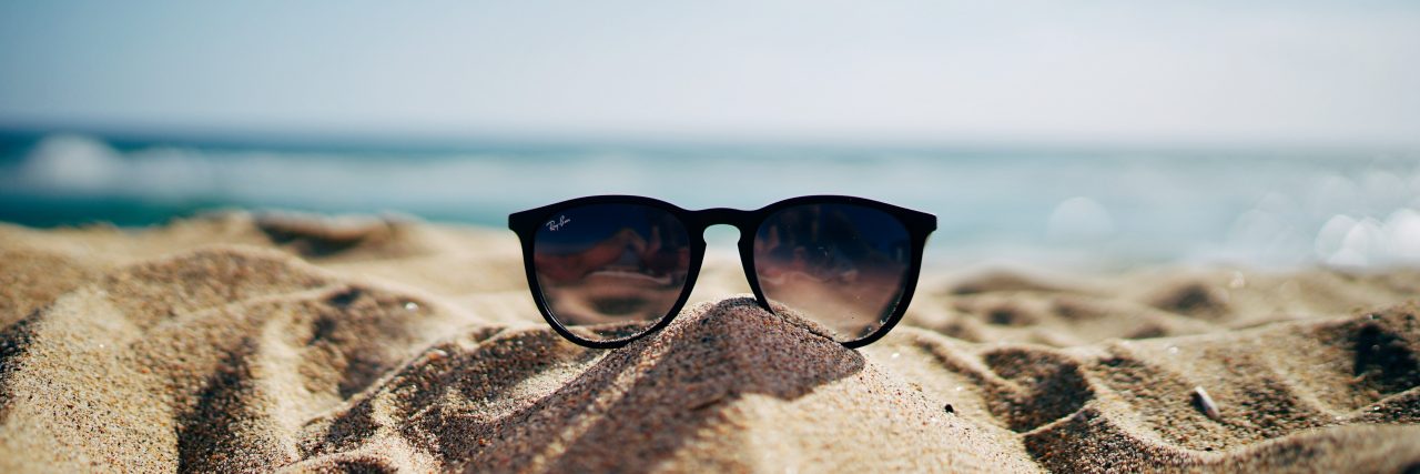 How to Take Care of Yourself When You're a Caregiver sunglasses on a beach