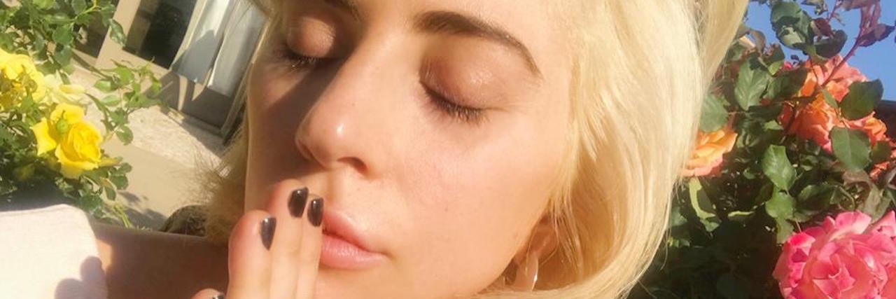 How Lady Gaga Has Helped Me Through Fibromyalgia and Chronic Pain lady gaga with her eyes closed standing outside by a rose bush