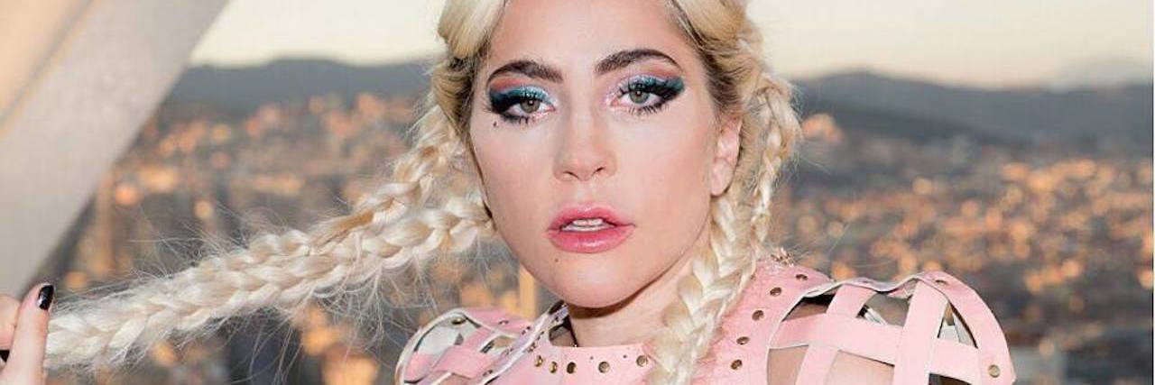 Why We Need to Support Lady Gaga After Her Canceled Joanne Tour lady gaga wearing pink with her hair in braids overlooking barcelona