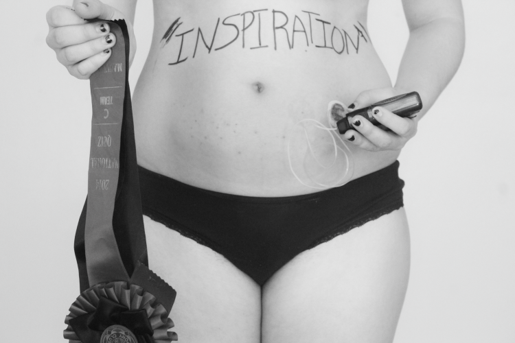 black and white photo of a woman standing in her underwear giving herself an injection in her stomach with the word 'inspiration' written across her abdomen