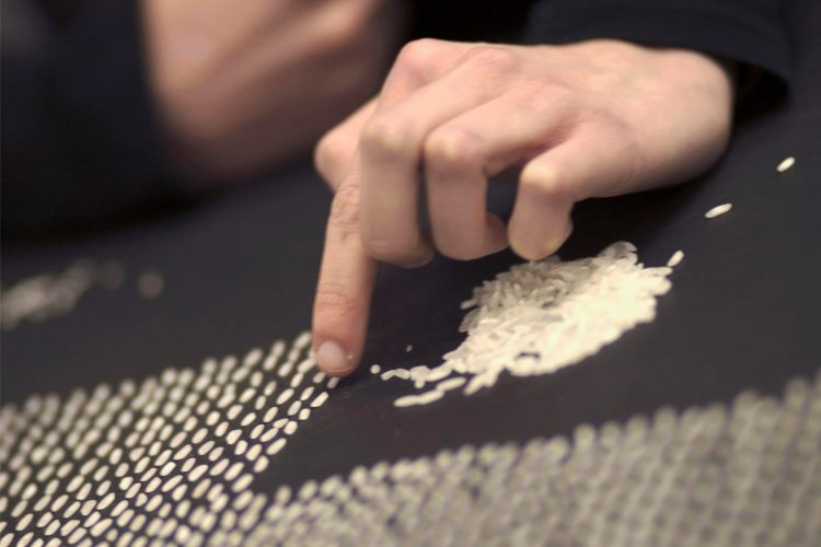 woman counting out grains of rice