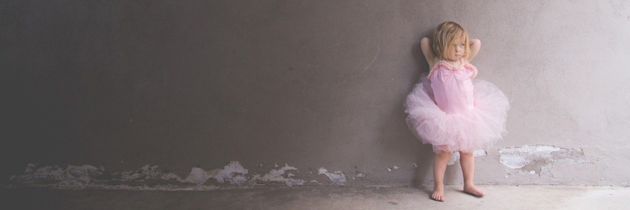 Little girl in pink ballet outfit.