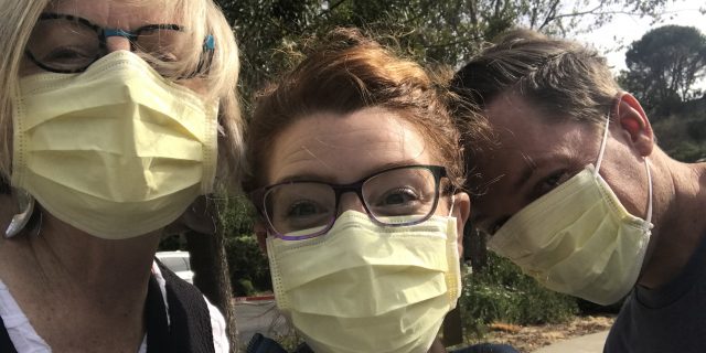 three people with hospital masks on