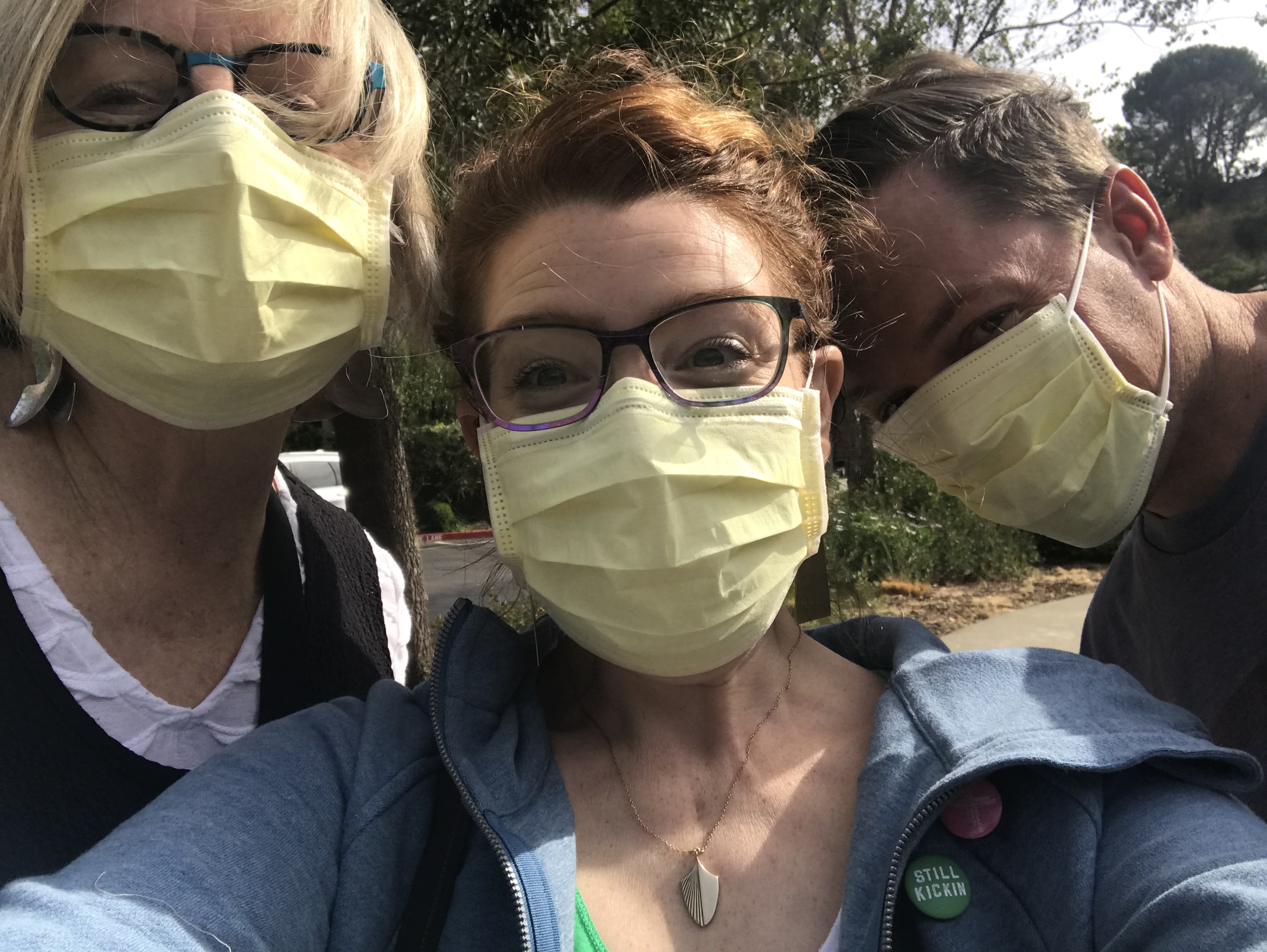 three people with hospital masks on