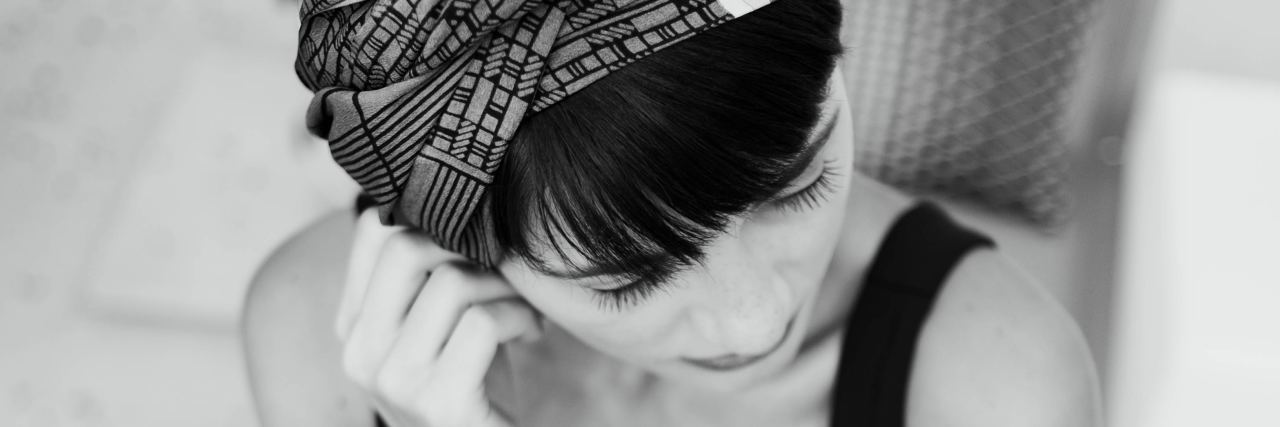 Mourning the Child I Never Had Because of Cancer sad woman sitting on the porch