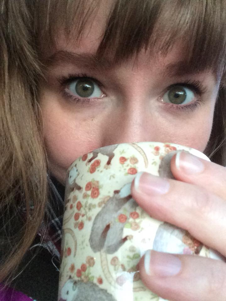 woman drinking out of a mug