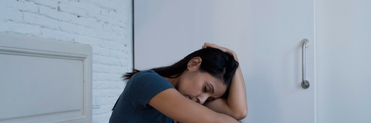 10 'Gross' Things People Do When They're Depressed A woman in bed. Text reads: 10 'Gross' Things You're Not the Only One Doing When You're Depressed