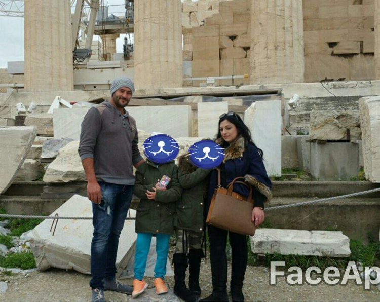 woman with her husband and two kids in front of the Acropolis in Greece