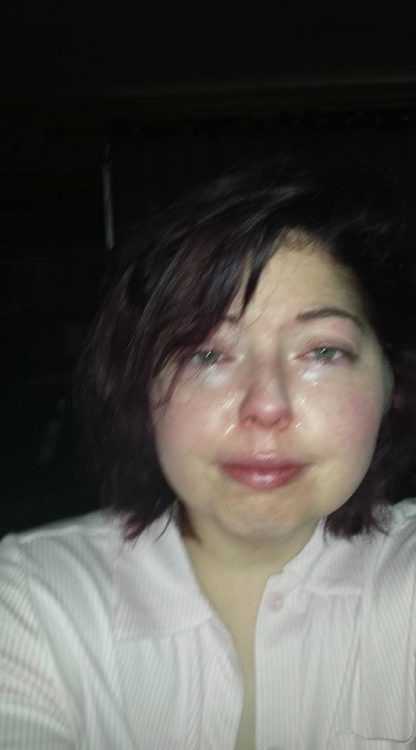 woman taking a selfie while crying