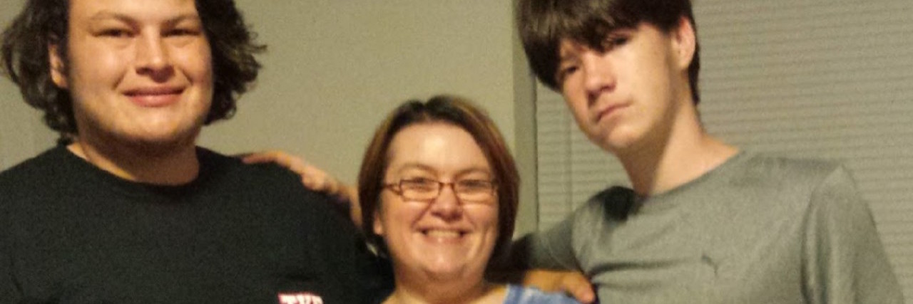 What I Learned From Getting Fibromyalgia as a Mother mother smiling with her two sons