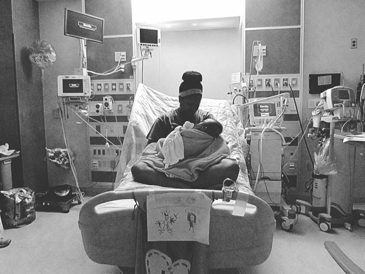 mom holding her baby in a hospital bed