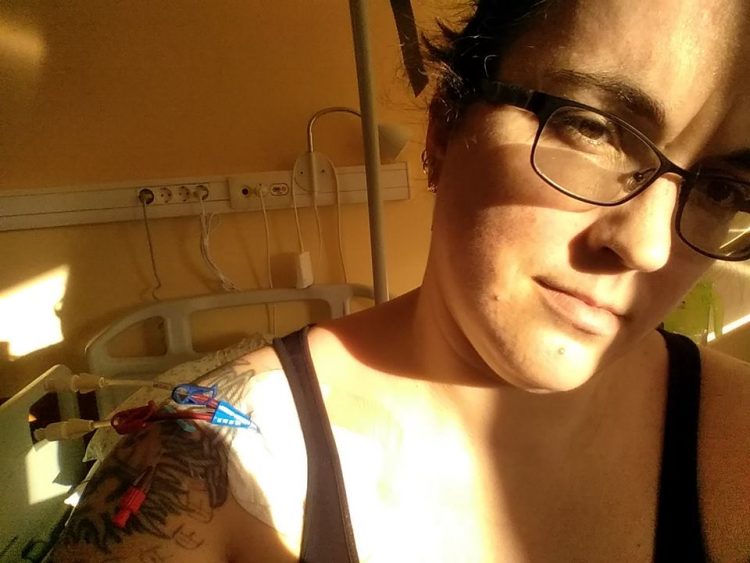 woman taking a selfie in the hospital with sunlight hitting her face and chest