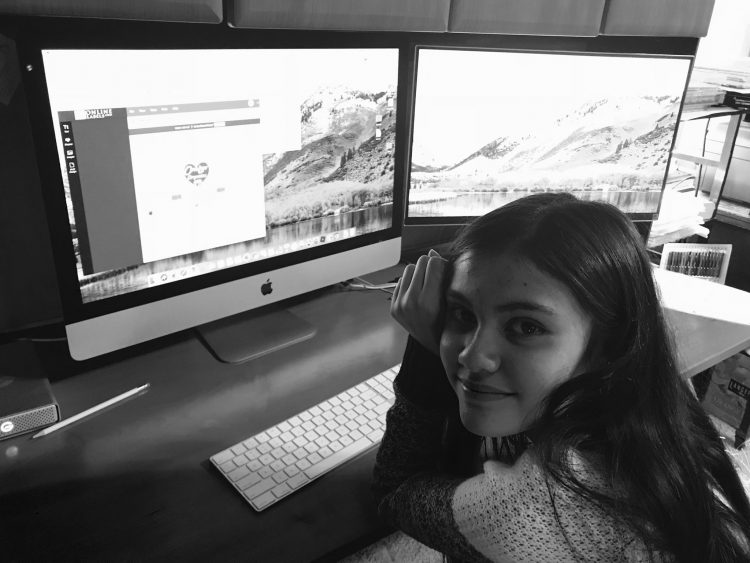 alexis bortell sitting in front of a computer