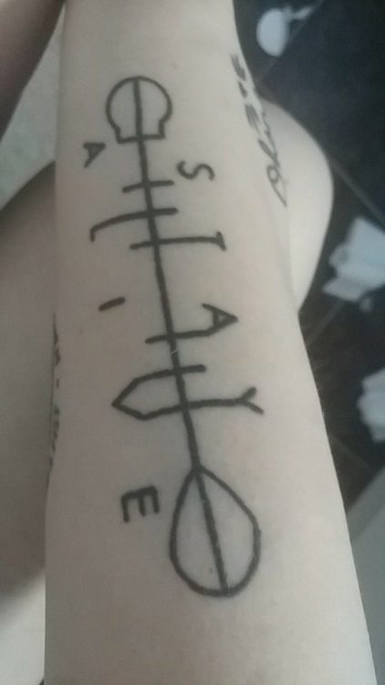 a tattoo of an arrow
