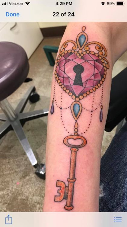 A tattoo of a heart-shaped key