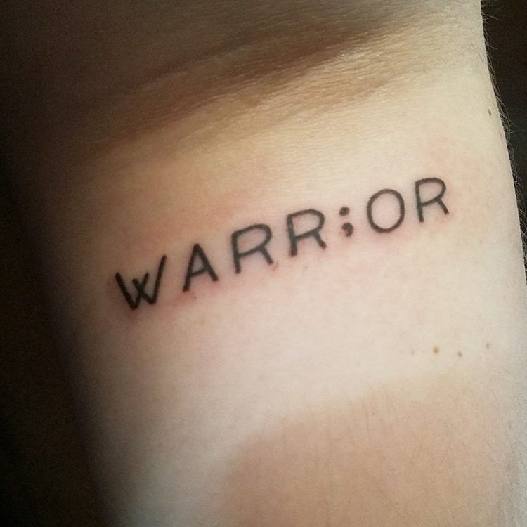 tattoo says warrior 