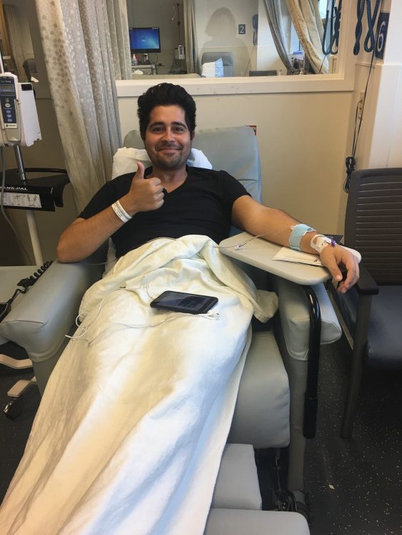 man in infusion chair giving thumbs up