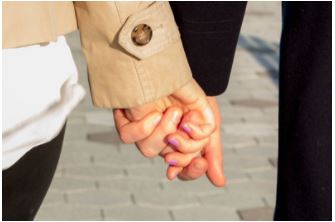 couple holding hands after getting engaged