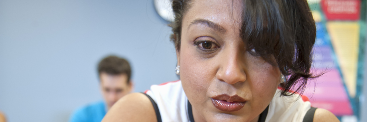 Going to Spin Class When Your Illness Means You Can't 'Keep Up' Woman using spin machine in gym