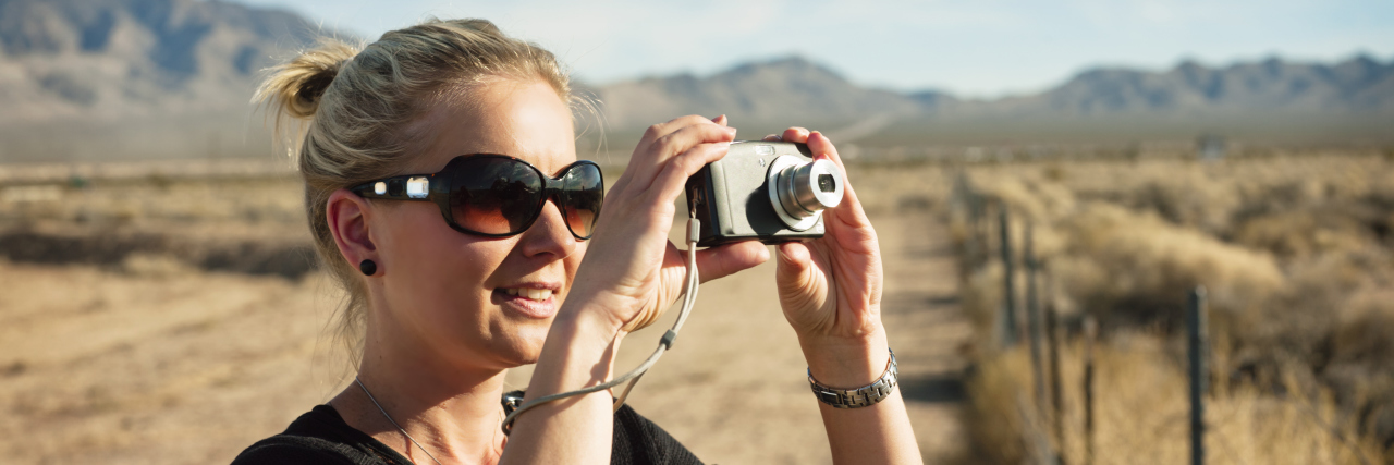 Learning to Appreciate Life When Your Spouse Is Ill Woman taking pictures in rural field
