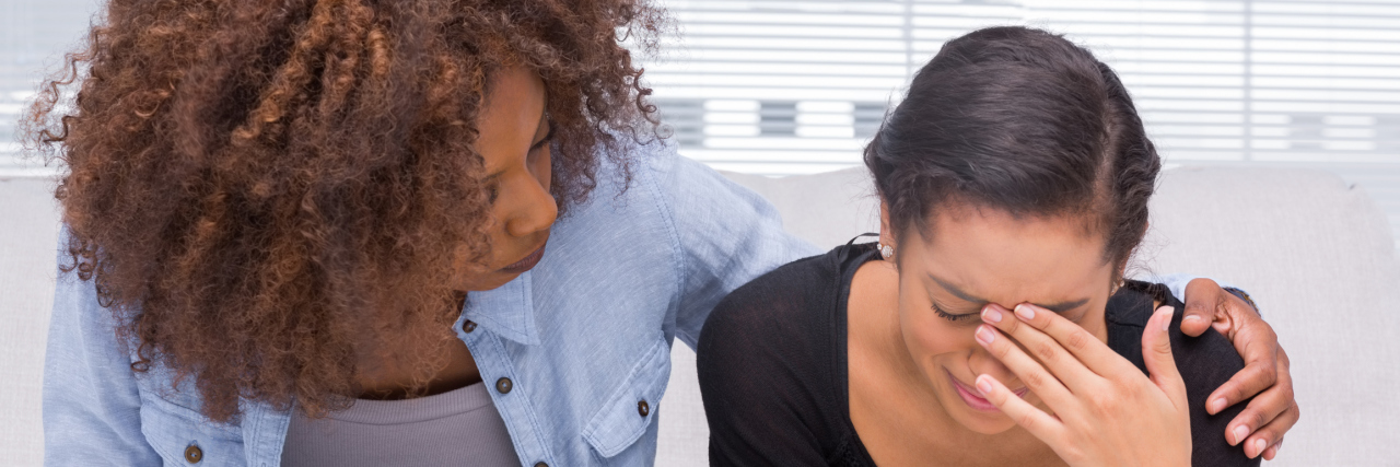 Why I've Been Apologizing Since My Diagnosis An African American woman comforting her friend.