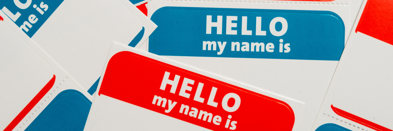 The Power in Giving a Name to Your Health Conditions a stack of red and blue 'hello, my name is' stickers
