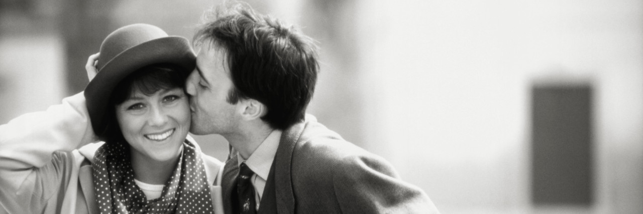 How Facial Expression Dyslexia and Autism Affected My Marriage Man kissing woman on cheek, outdoors